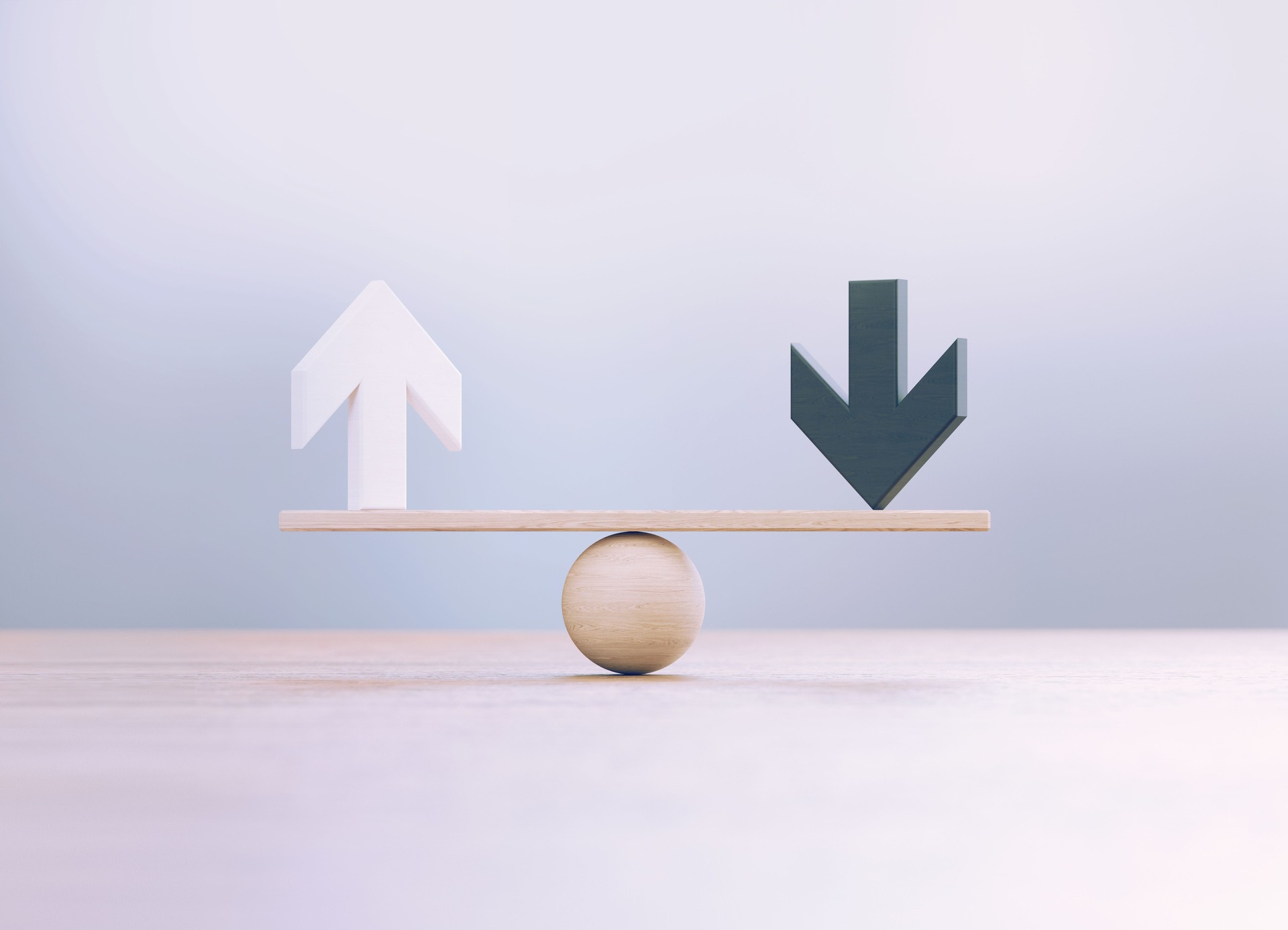 White And Black Wooden Arrow Symbols Sitting Over Wooden Seesaw Scale Before Defocused Background